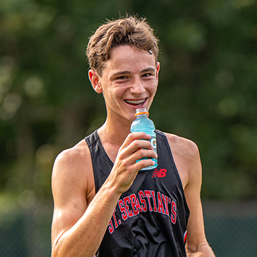 A cross country athlete drinking a Gatorade. Links to Beneficiary Designations 