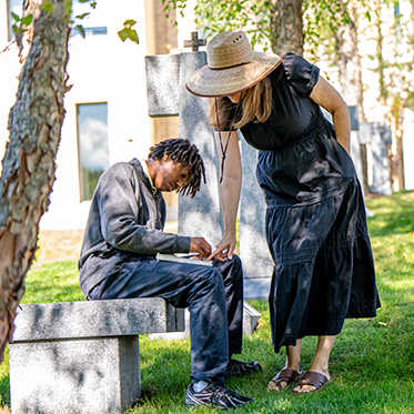 A teacher helping a student. Links to Gifts of Appreciated Securities
